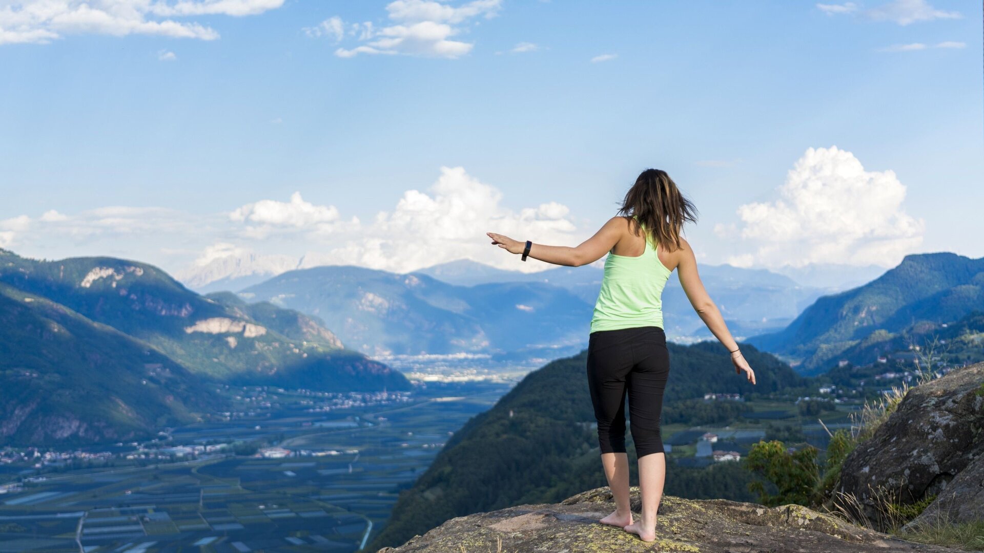 Woman standing on St. Hippolyt Hill in Naraun with stunning view of the South Tyrolean mountains, South Tyrol